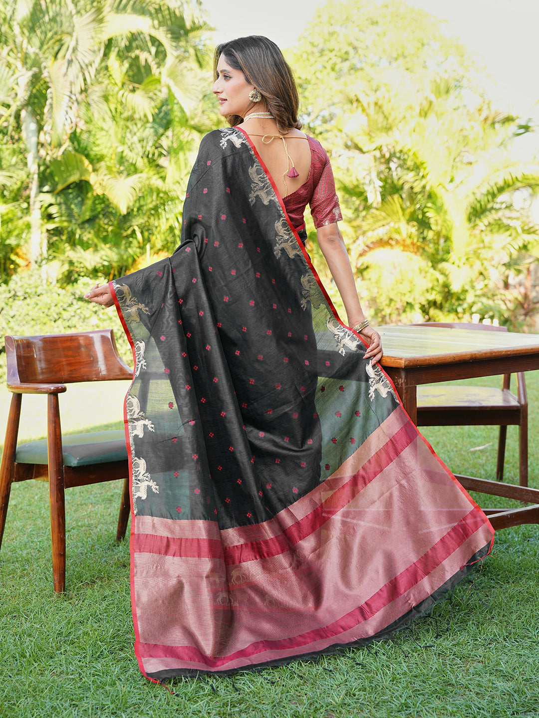 Black and red colored raw silk saree with tassles on pallu