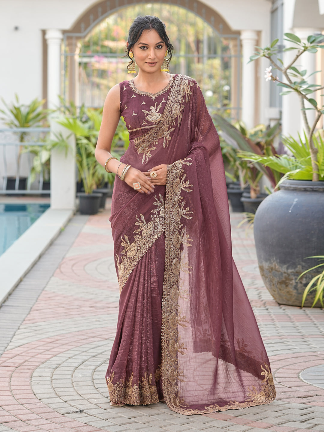 Dusty brown colored shimmer georgette based jari embroidered saree