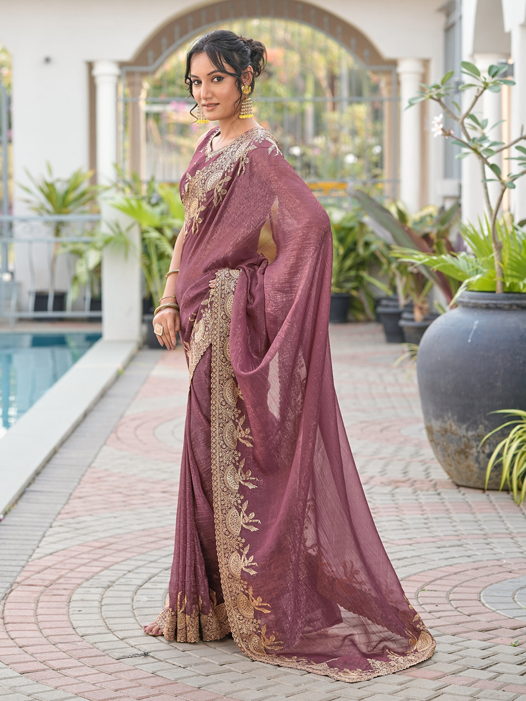 Dusty brown colored shimmer georgette based jari embroidered saree