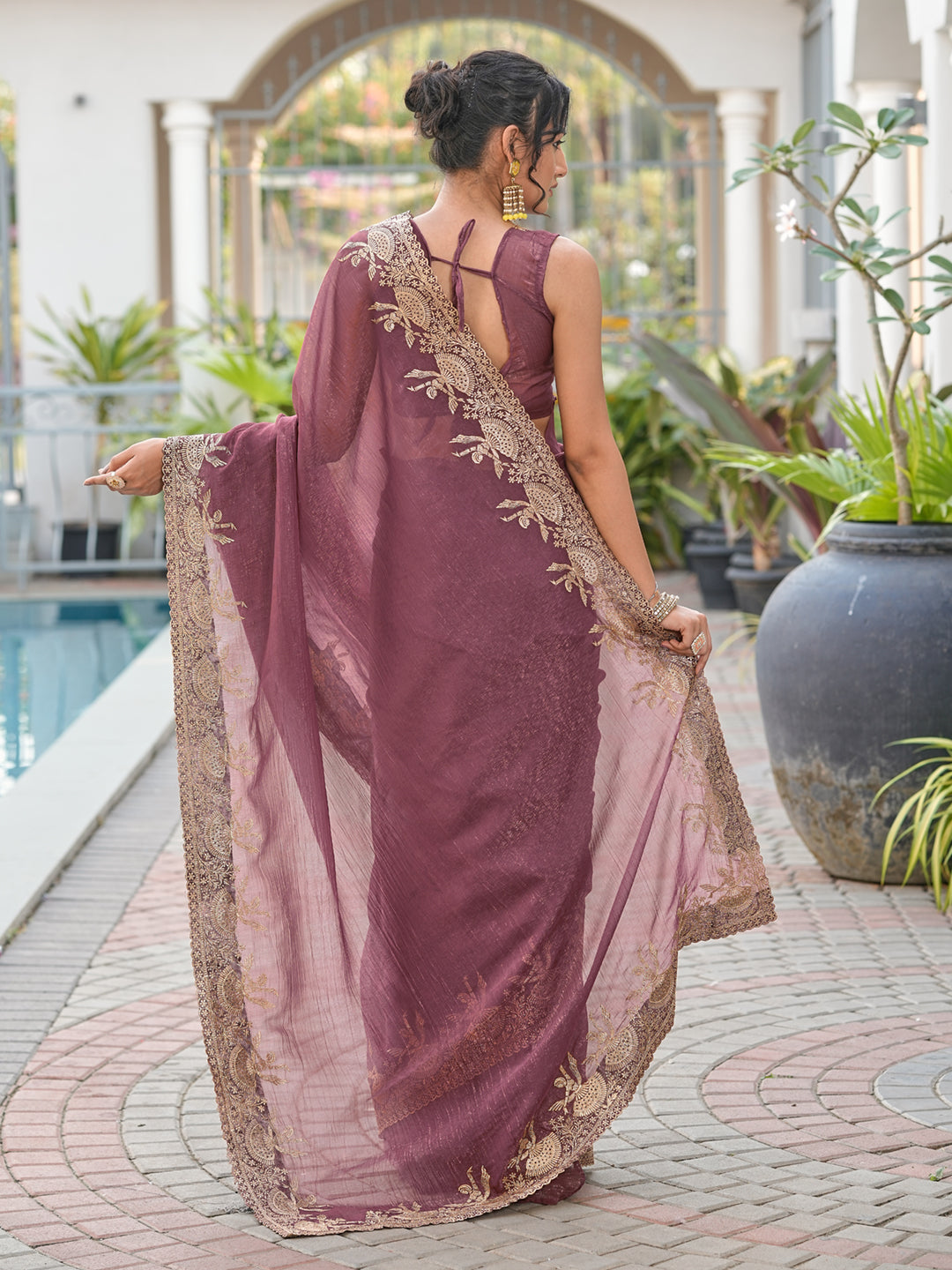 Dusty brown colored shimmer georgette based jari embroidered saree