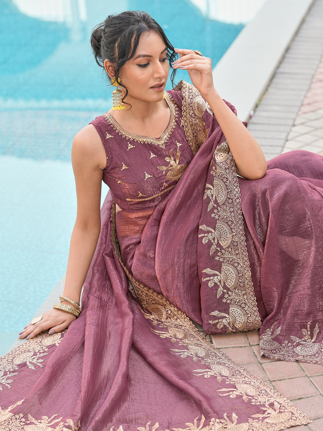 Dusty brown colored shimmer georgette based jari embroidered saree