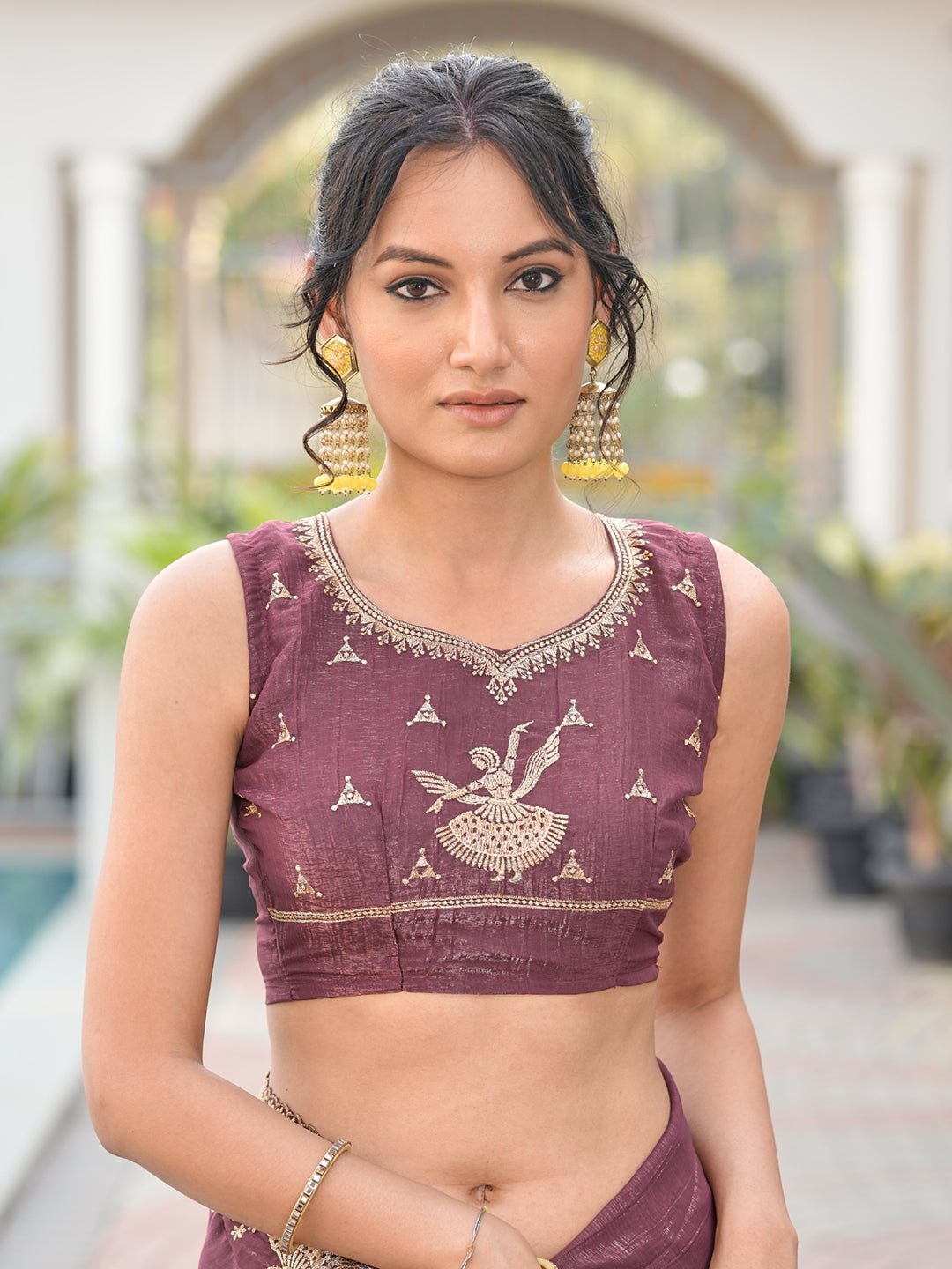 Dusty brown colored shimmer georgette based jari embroidered saree