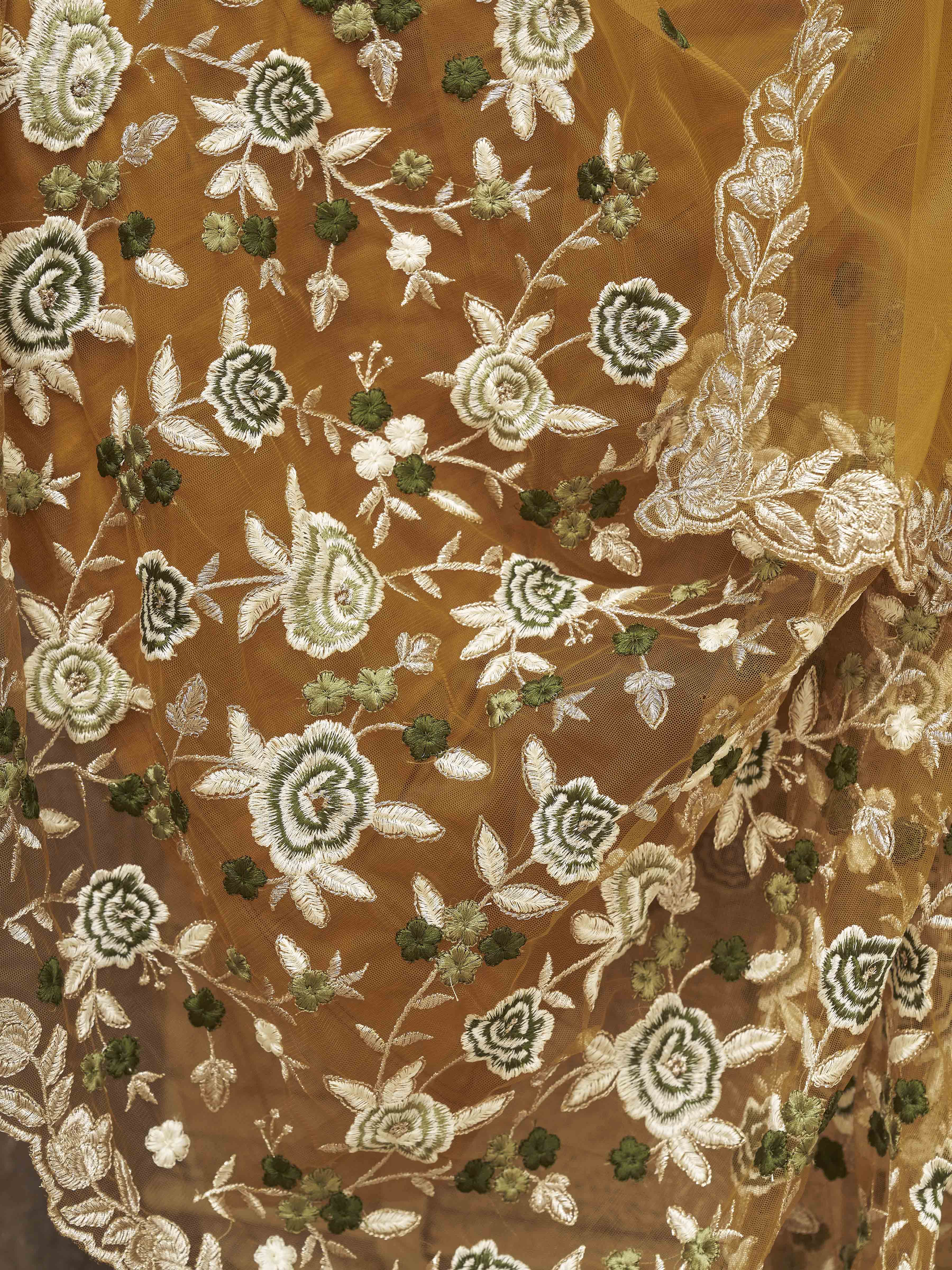 Mustard colored embroidered net saree