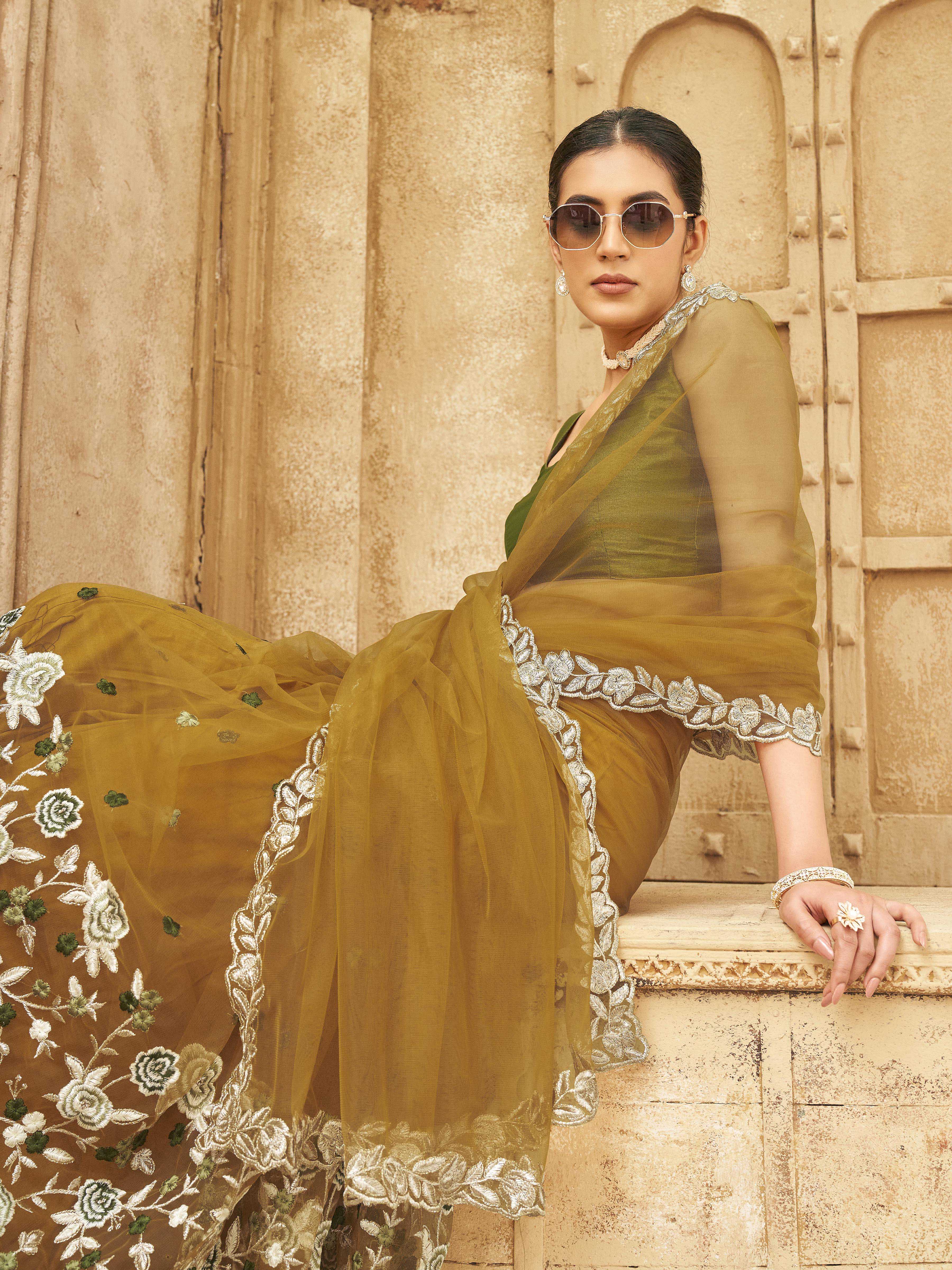 Mustard colored embroidered net saree