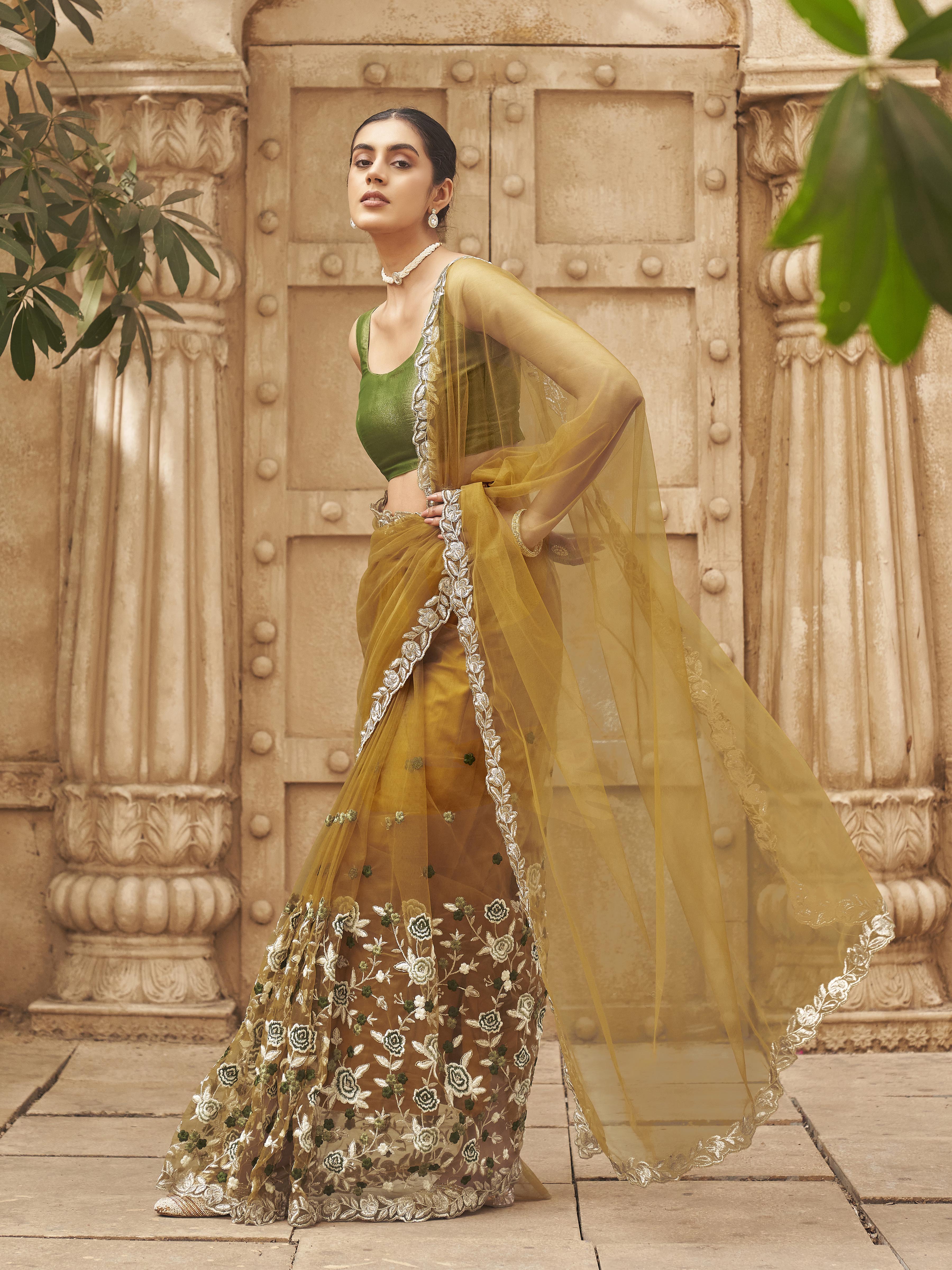 Mustard colored embroidered net saree