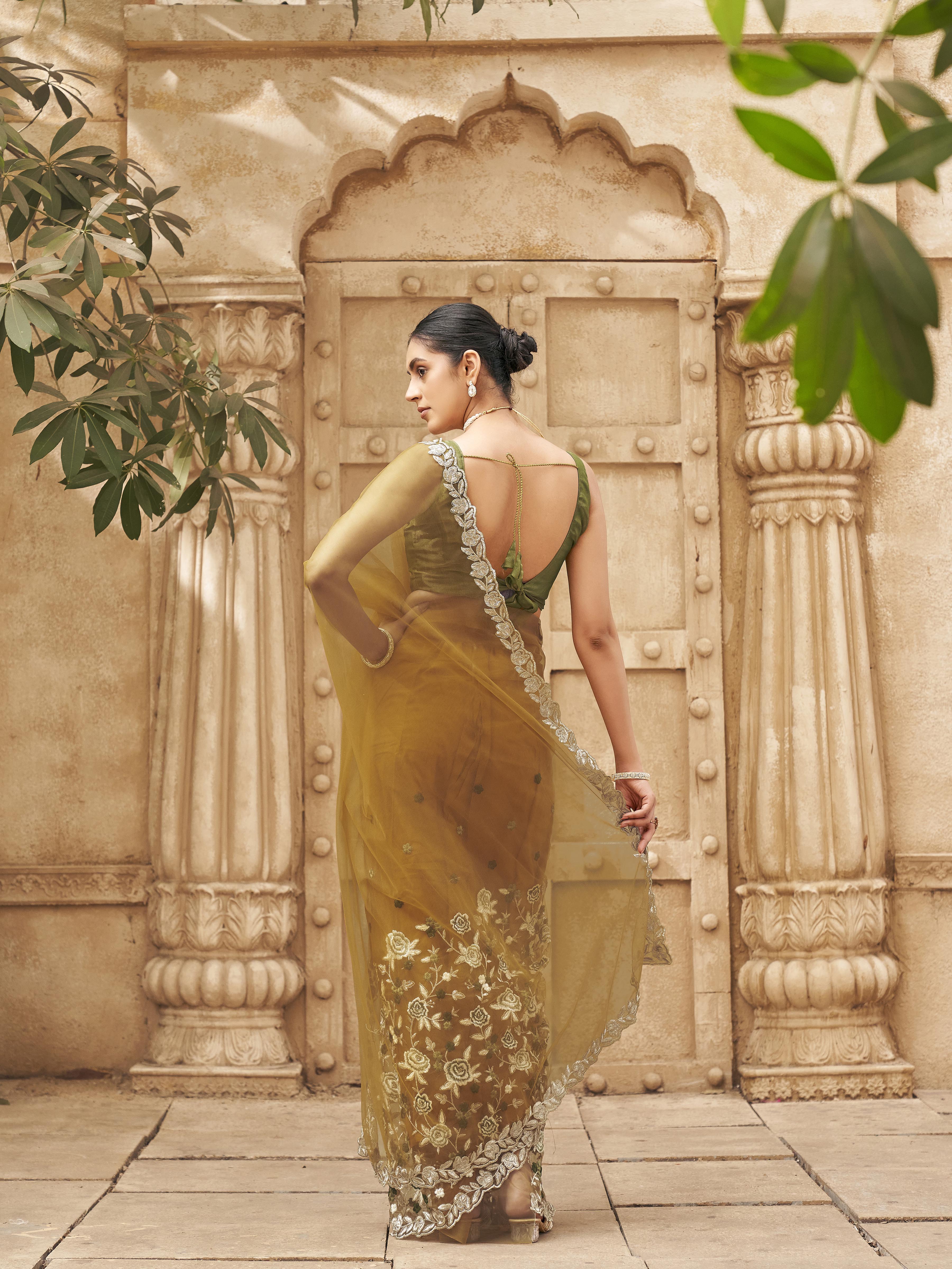 Mustard colored embroidered net saree