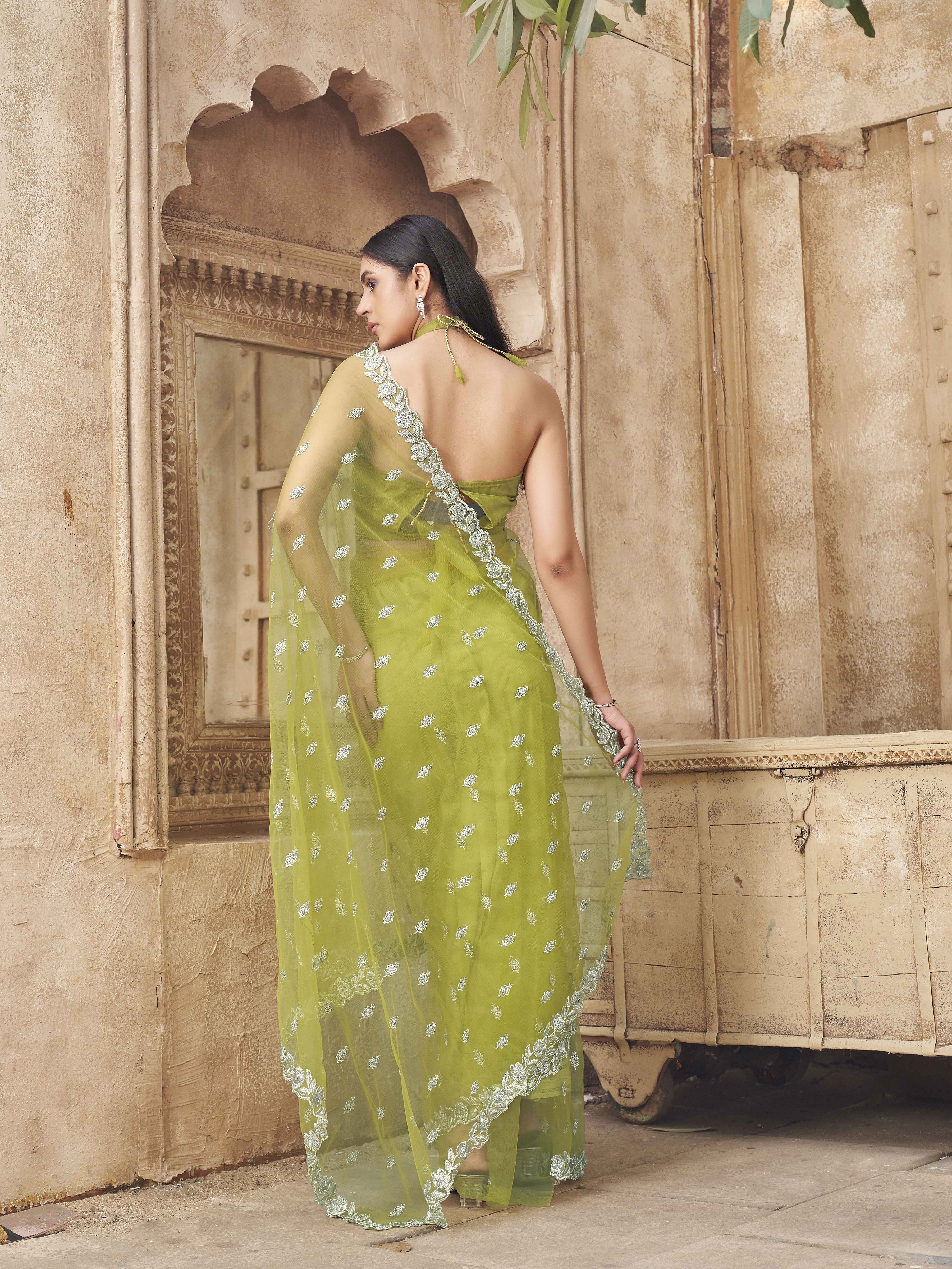 Neon green colored embroidered designer net saree with faux diamond