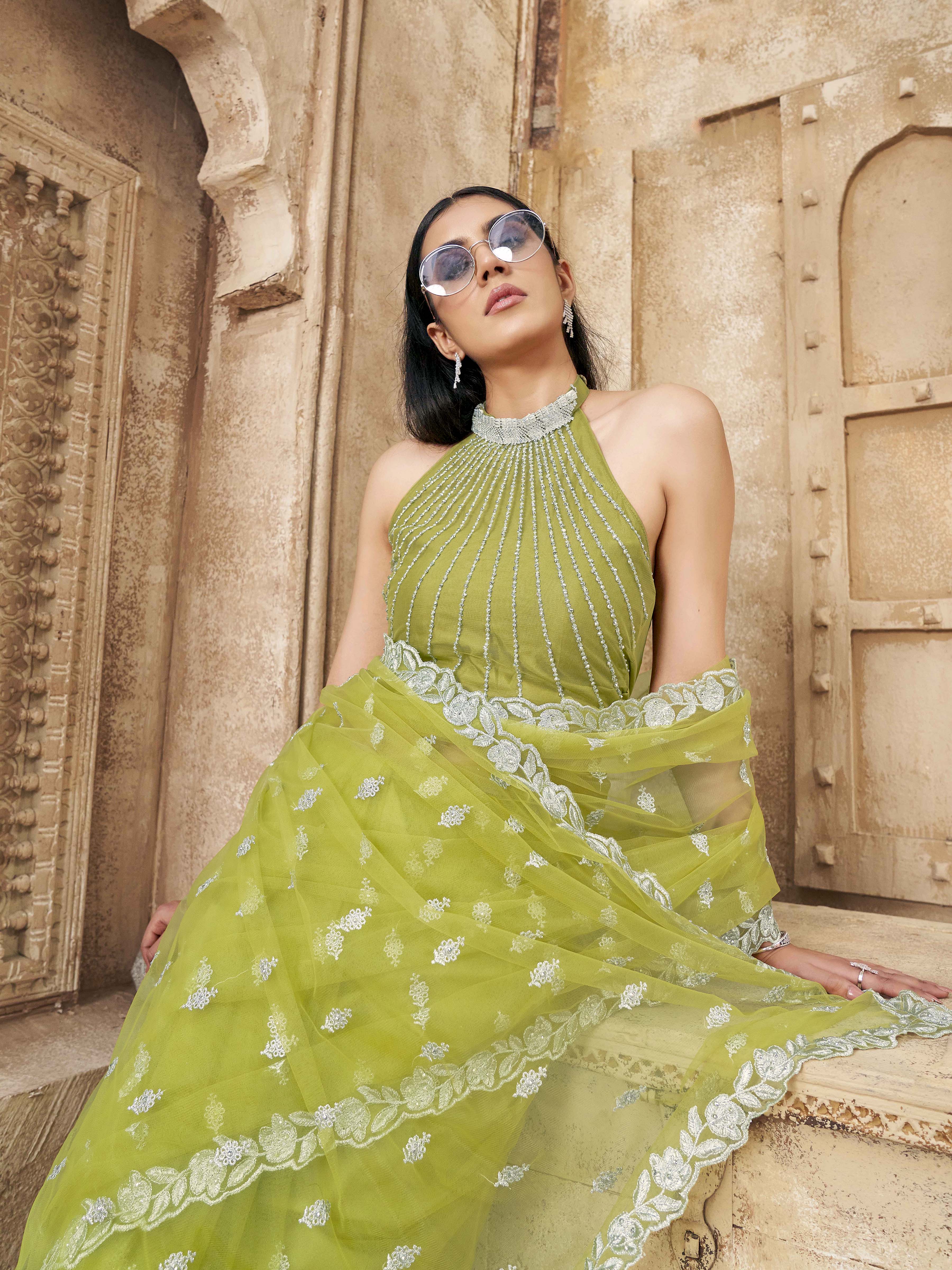 Neon green colored embroidered designer net saree with faux diamond
