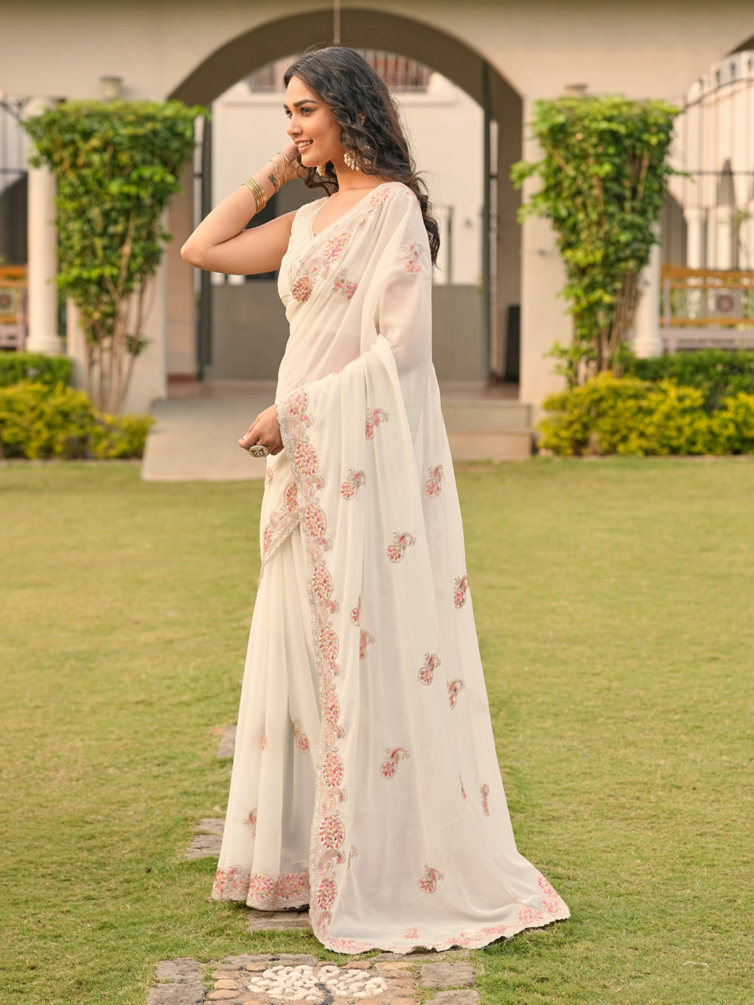 Off white colored shimmer georgette base embroidered saree