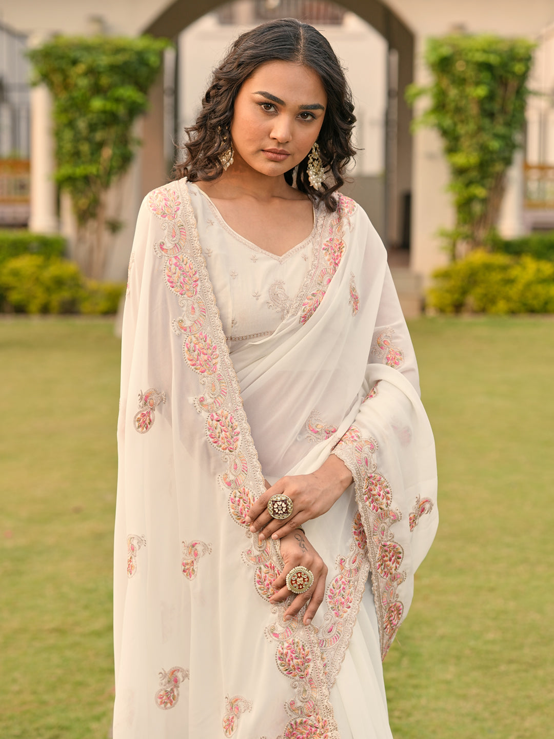 Off white colored shimmer georgette base embroidered saree