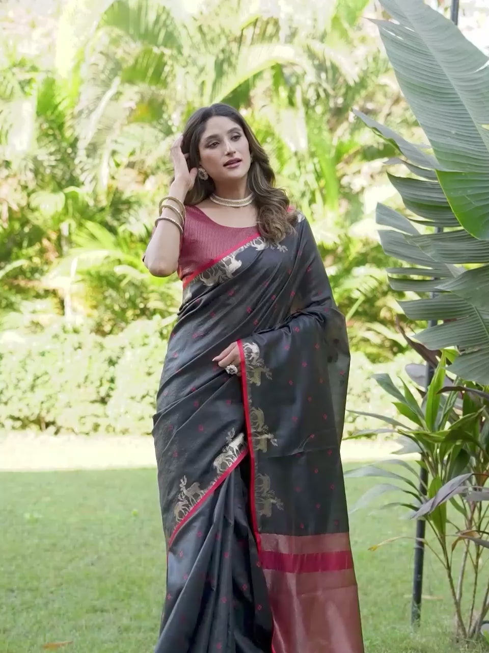 Black and red colored raw silk saree with tassles on pallu