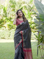 Black and red colored raw silk saree with tassles on pallu
