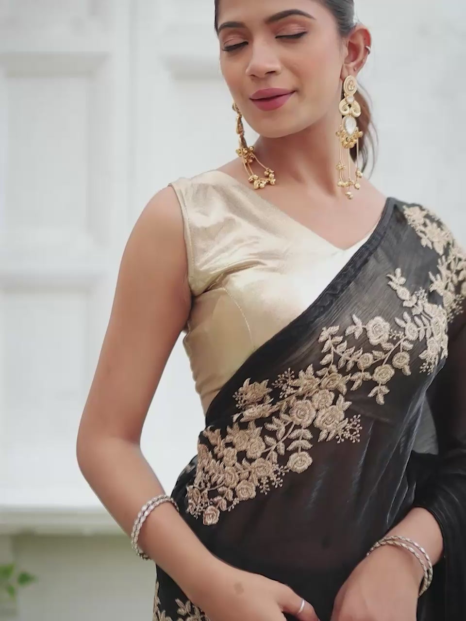 Black colored zari embroidered designer saree with tassles on pallu