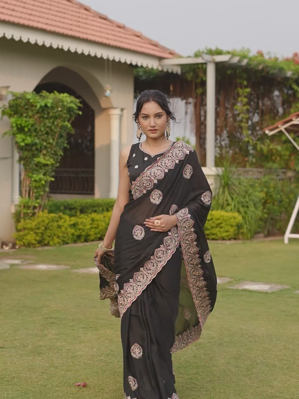 Black colored shimmer georgette base embroidered saree